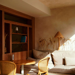 Cozy living room corner with natural light, wooden shelves, comfy seating, and stylish lamp for decor inspiration.