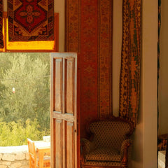 Cozy corner showcasing vibrant area rugs and a classic wooden door in a charming room.